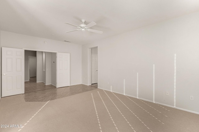 unfurnished bedroom with light colored carpet and ceiling fan