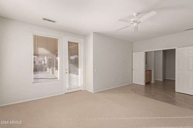 spare room featuring ceiling fan and carpet