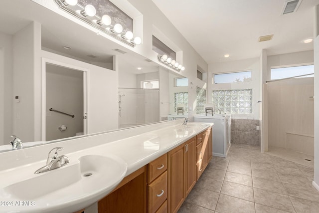 bathroom featuring walk in shower, vanity, and tile patterned flooring