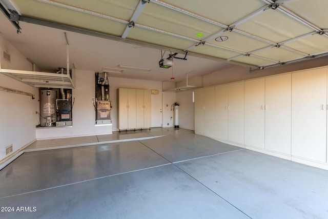 garage featuring a garage door opener and water heater