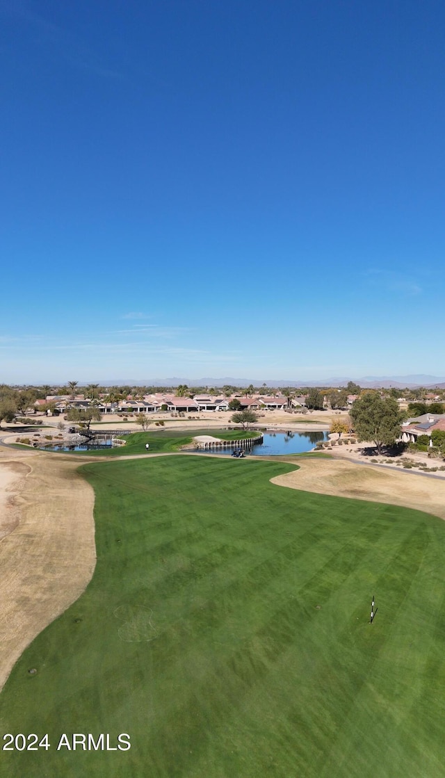 view of community featuring a water view and a yard