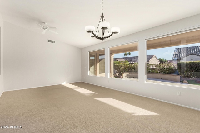 unfurnished room with ceiling fan with notable chandelier, carpet flooring, and vaulted ceiling