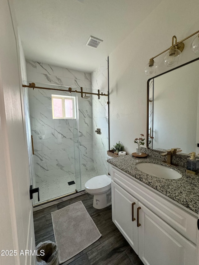 4173 W 27th Ln, Yuma, AZ 85364 - bathroom featuring a marble finish shower, vanity, and wood finished floors