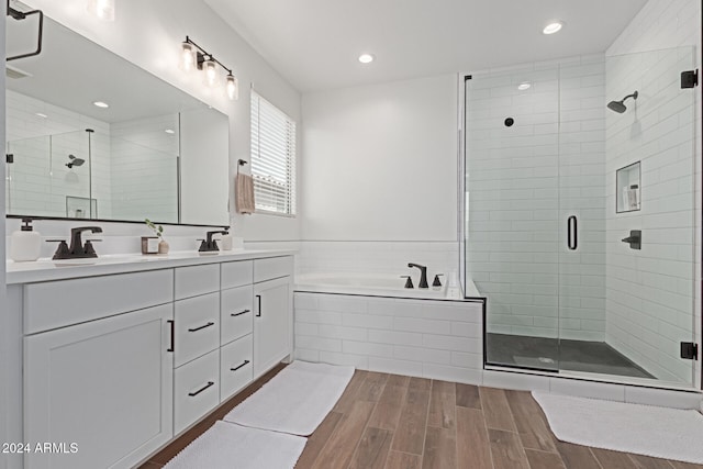 bathroom featuring separate shower and tub, vanity, and wood-type flooring