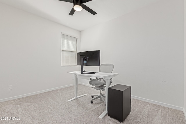 carpeted office featuring ceiling fan