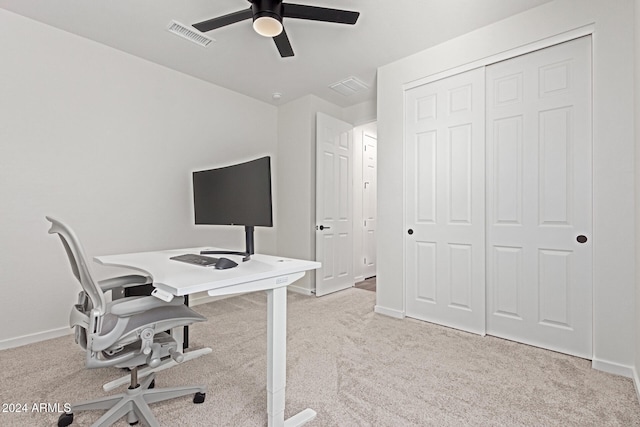 home office with ceiling fan and light carpet