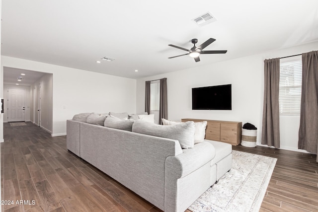 living room with ceiling fan and dark hardwood / wood-style floors