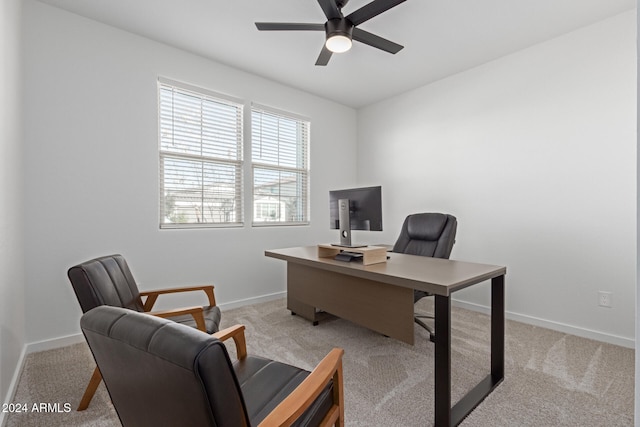 home office with light carpet and ceiling fan