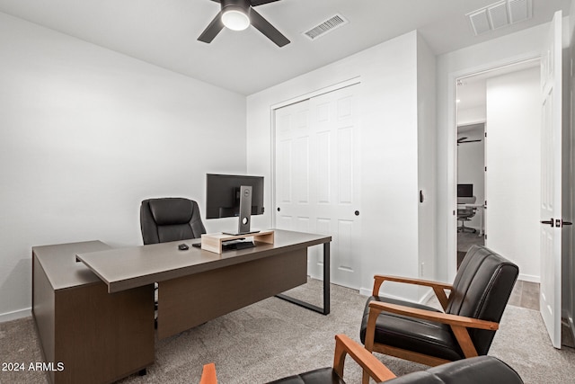 carpeted home office with ceiling fan