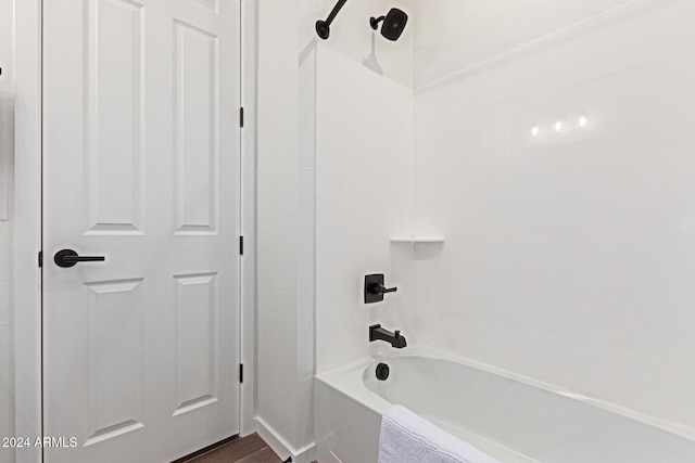 bathroom with hardwood / wood-style floors and shower / bathtub combination