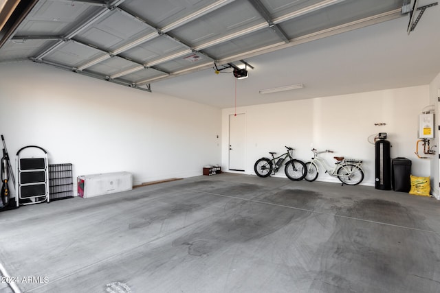 garage with a garage door opener and water heater