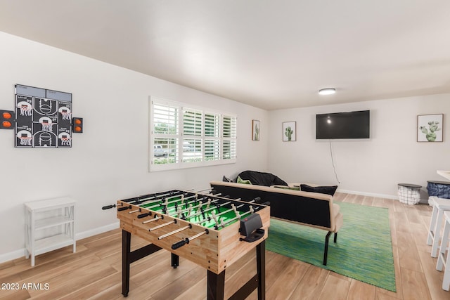 rec room featuring wood finished floors and baseboards