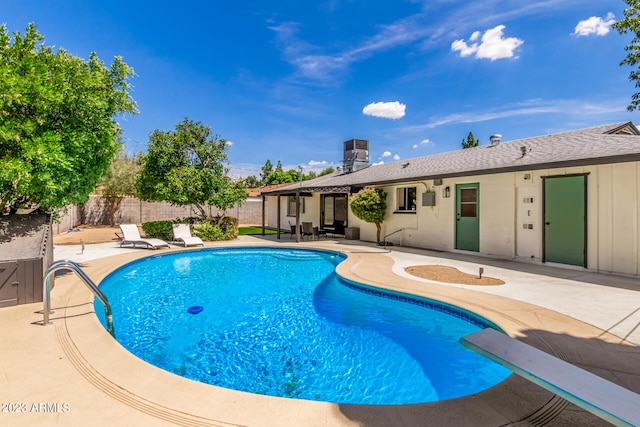 view of pool featuring a patio area and central air condition unit