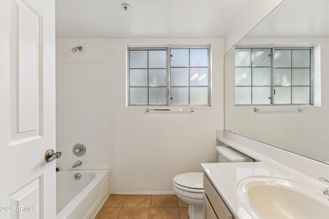 full bathroom with tile patterned flooring, vanity, tiled shower / bath combo, and toilet