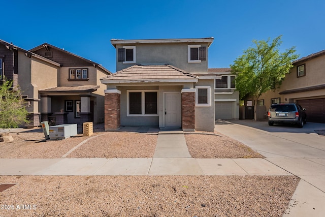 4010 W Fremont Rd, Phoenix, AZ 85041 - view of front of property with driveway, stucco siding, a garage, and brick siding