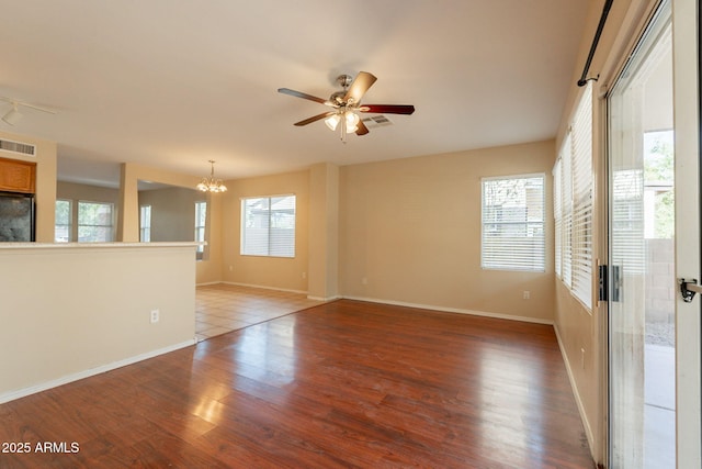 4010 W Fremont Rd, Phoenix, AZ 85041 - empty room with a chandelier, wood finished floors, a ceiling fan, and baseboards