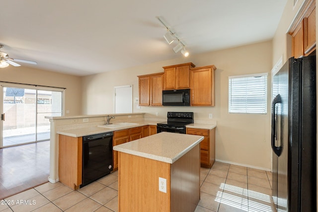 4010 W Fremont Rd, Phoenix, AZ 85041 - kitchen featuring black appliances, a sink, a peninsula, light countertops, and light tile patterned floors