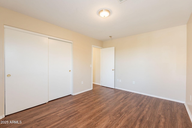 4010 W Fremont Rd, Phoenix, AZ 85041 - unfurnished bedroom featuring wood finished floors, baseboards, and a closet