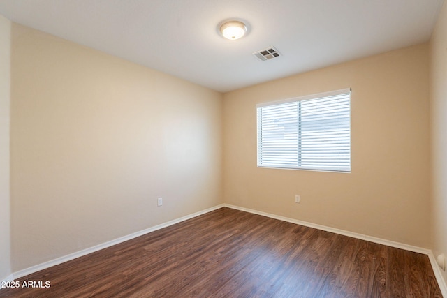 4010 W Fremont Rd, Phoenix, AZ 85041 - empty room featuring dark wood-style floors and baseboards