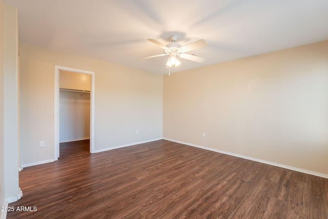 4010 W Fremont Rd, Phoenix, AZ 85041 - unfurnished bedroom featuring dark wood finished floors, baseboards, a spacious closet, a closet, and a ceiling fan