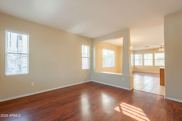 4010 W Fremont Rd, Phoenix, AZ 85041 - empty room with baseboards, wood finished floors, and a ceiling fan