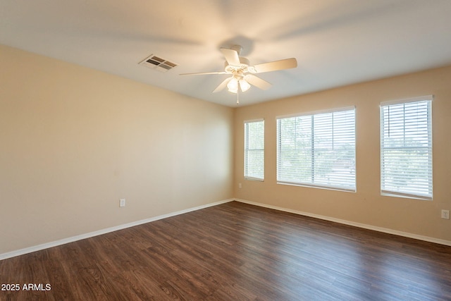 4010 W Fremont Rd, Phoenix, AZ 85041 - unfurnished room featuring dark wood-style flooring, a ceiling fan, plenty of natural light, and baseboards