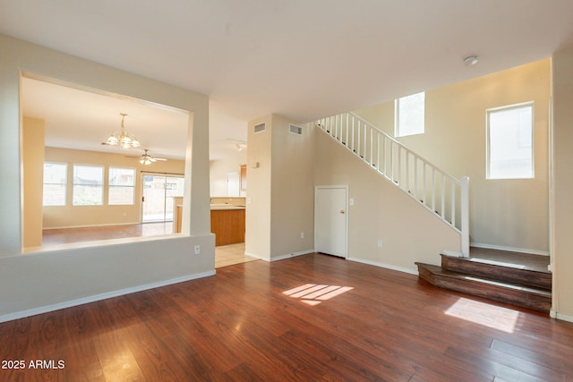 4010 W Fremont Rd, Phoenix, AZ 85041 - unfurnished living room featuring a chandelier, stairs, wood finished floors, and baseboards