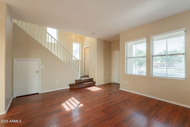 4010 W Fremont Rd, Phoenix, AZ 85041 - unfurnished living room with wood finished floors, baseboards, and stairs