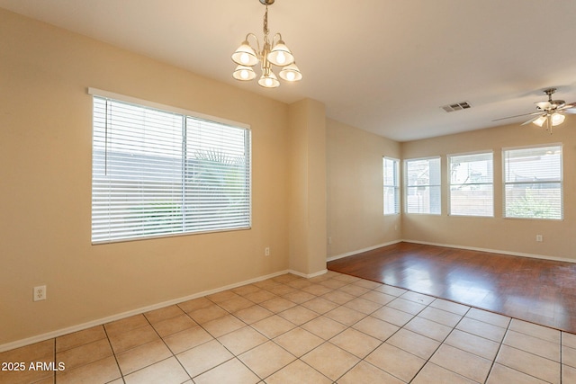 4010 W Fremont Rd, Phoenix, AZ 85041 - spare room with a chandelier, a ceiling fan, light tile patterned floors, and baseboards