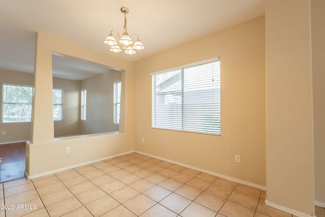 4010 W Fremont Rd, Phoenix, AZ 85041 - spare room featuring a chandelier, baseboards, and light tile patterned floors