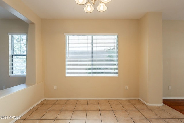 4010 W Fremont Rd, Phoenix, AZ 85041 - unfurnished room featuring a chandelier, light tile patterned floors, and baseboards