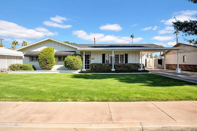 single story home with a carport, board and batten siding, and a front yard