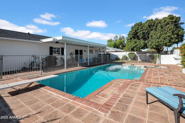 view of swimming pool with a diving board, a patio area, a fenced in pool, and a fenced backyard