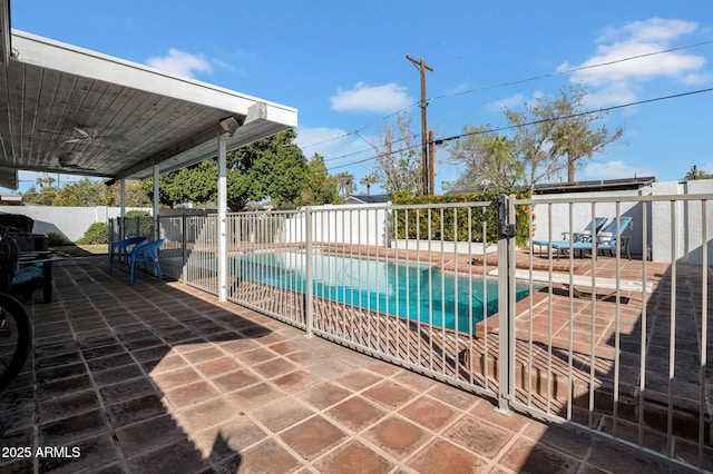 view of pool featuring a fenced in pool, fence, a ceiling fan, and a patio area