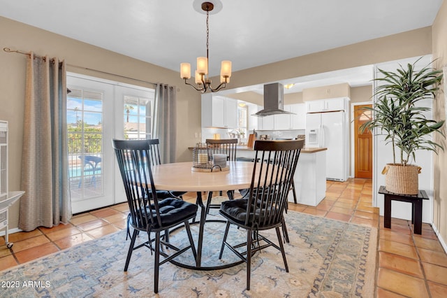 dining room with light tile patterned flooring, french doors, and a chandelier