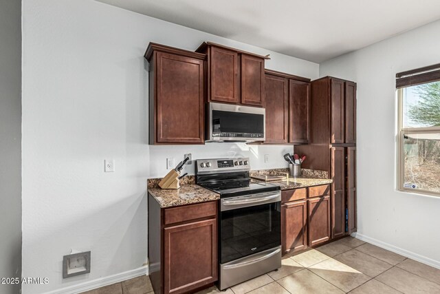 7090 S 252nd Dr, Buckeye, AZ 85326 - kitchen with appliances with stainless steel finishes, light stone counters, baseboards, and light tile patterned floors