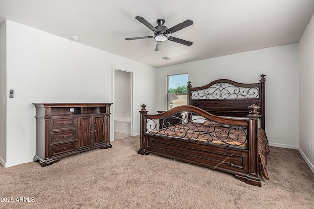 7090 S 252nd Dr, Buckeye, AZ 85326 - bedroom featuring light carpet, baseboards, ensuite bathroom, and a ceiling fan