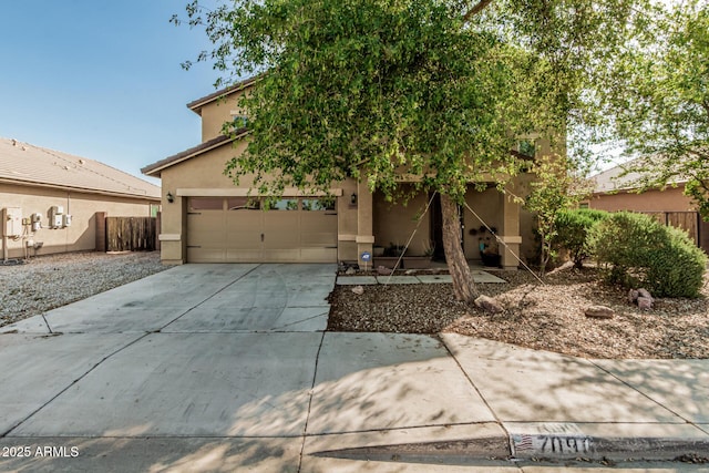 7090 S 252nd Dr, Buckeye, AZ 85326 - view of front of home with stucco siding, concrete driveway, and a garage