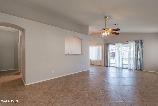 spare room featuring ceiling fan, light tile patterned flooring, and lofted ceiling