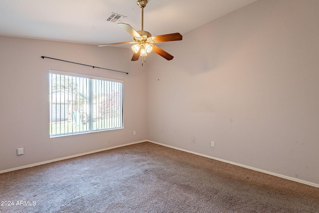 carpeted spare room featuring ceiling fan and lofted ceiling