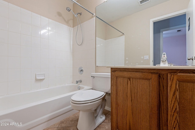 full bathroom featuring tile patterned flooring, vanity, toilet, and tiled shower / bath combo