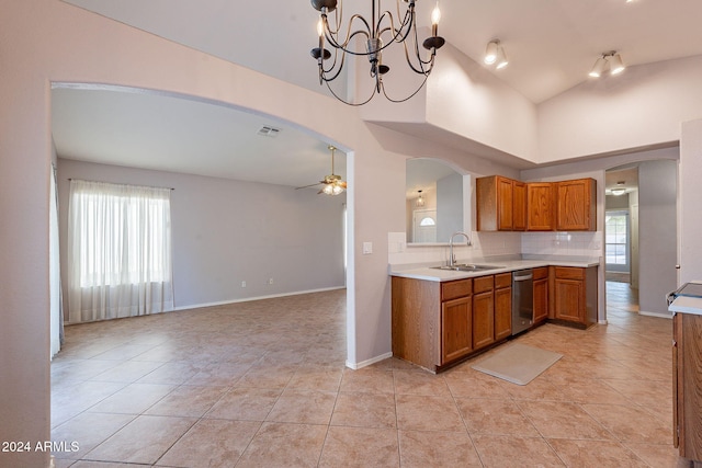 kitchen featuring ceiling fan with notable chandelier, light tile patterned flooring, decorative backsplash, and sink