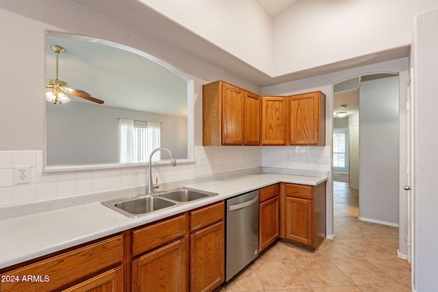 kitchen with dishwasher, sink, ceiling fan, light tile patterned floors, and tasteful backsplash