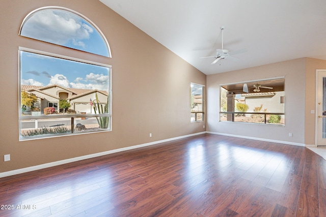 unfurnished living room featuring ceiling fan, dark hardwood / wood-style floors, and vaulted ceiling