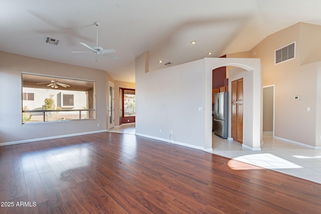 spare room with plenty of natural light, lofted ceiling, ceiling fan, and light hardwood / wood-style flooring