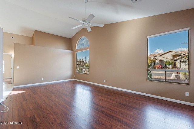 empty room featuring ceiling fan, lofted ceiling, and dark hardwood / wood-style floors