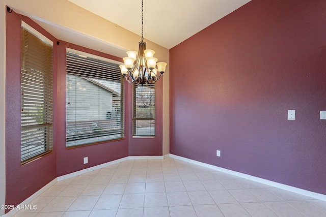 empty room featuring vaulted ceiling and a chandelier