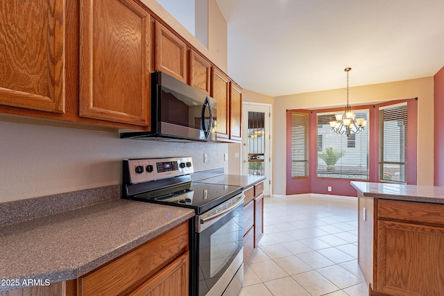 kitchen with a notable chandelier, light tile patterned floors, decorative light fixtures, and stainless steel appliances