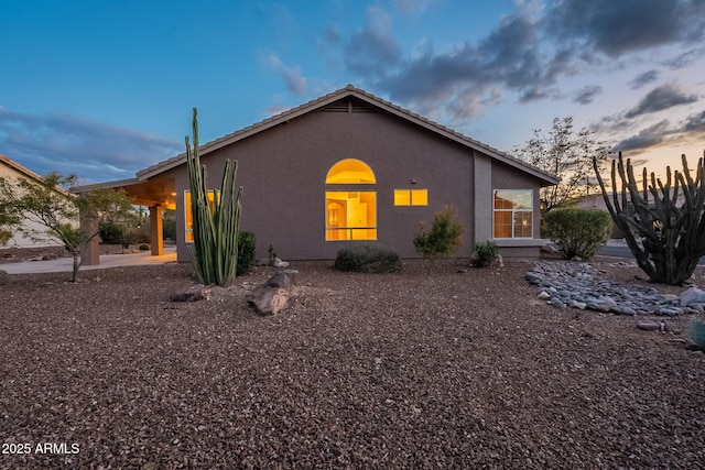 property exterior at dusk with a carport