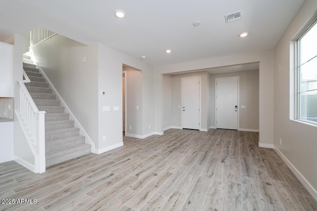 1571 E Tiffany Way, Gilbert, AZ 85298 - unfurnished living room featuring light wood-style floors, stairway, baseboards, and recessed lighting